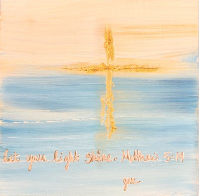 Small square painting with a horizon line of blue and peach, featuring a centered gold cross and the verse: "Let your light shine. Matthew 5:14."